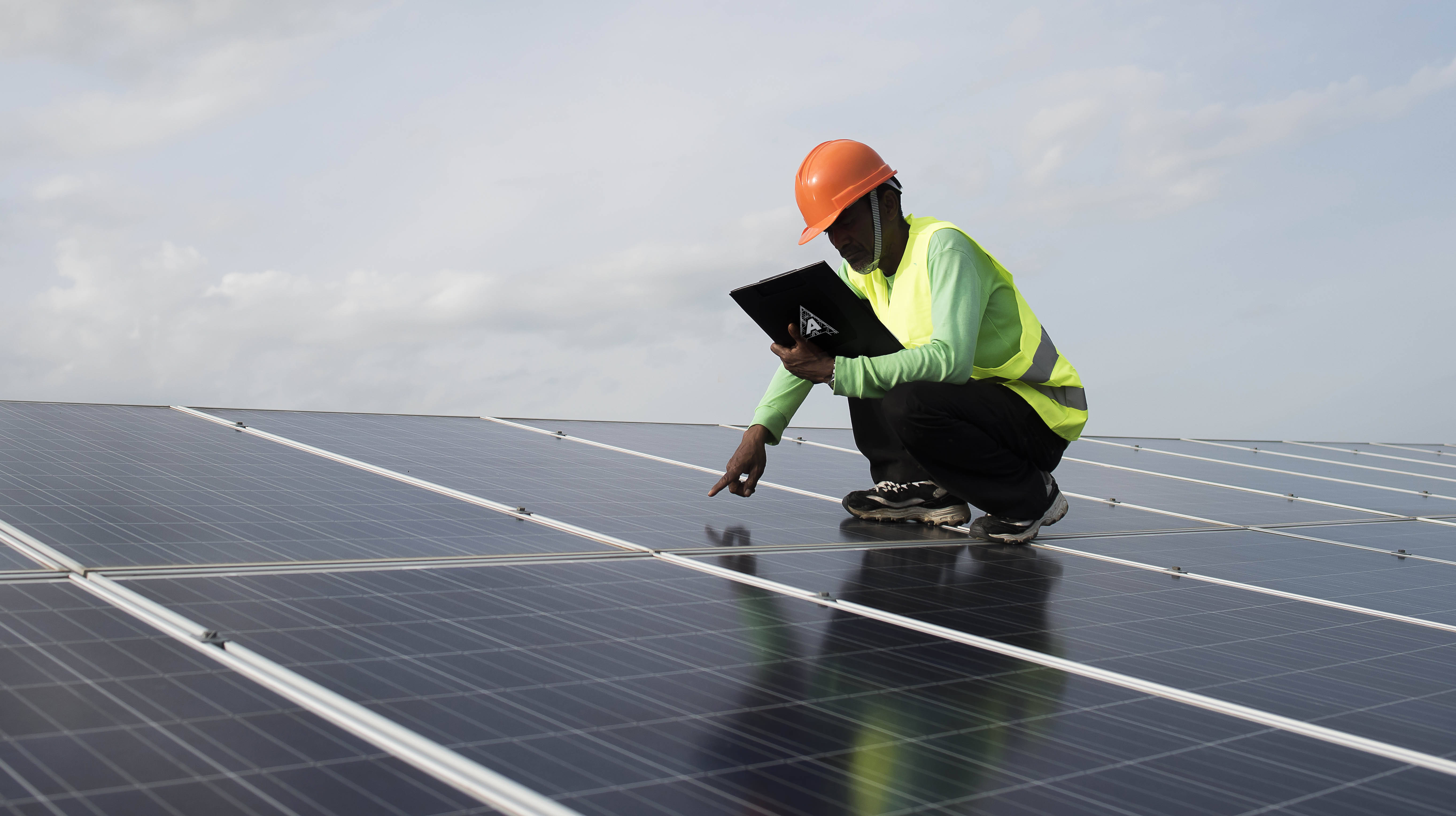 Technician engineer checks the maintenance of the solar cell panels.